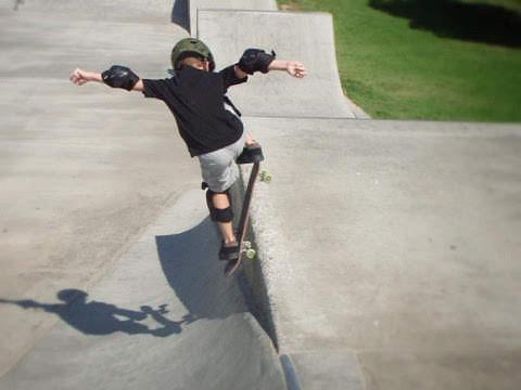 a picture of a boy skating, filtered